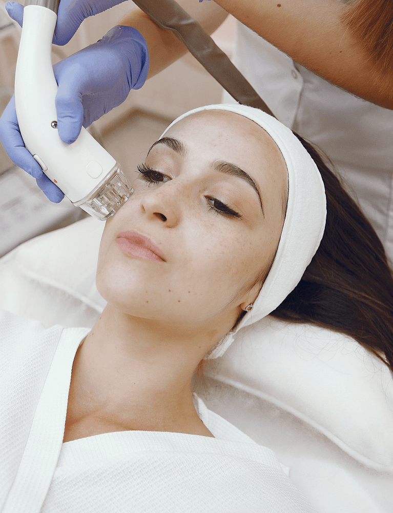 Dermatologist performing a carbon laser facial treatment on a patient at a skin clinic in Chennai.