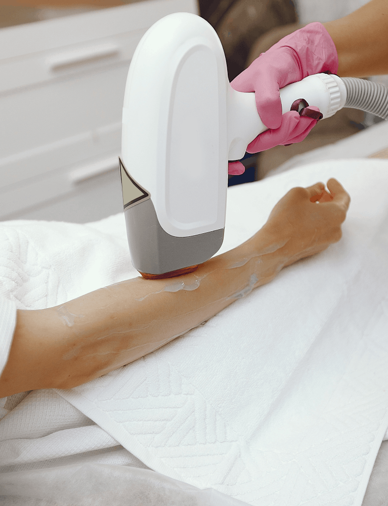 Dermatologist performing laser hair reduction treatment on a patient at a skin clinic in Chennai.