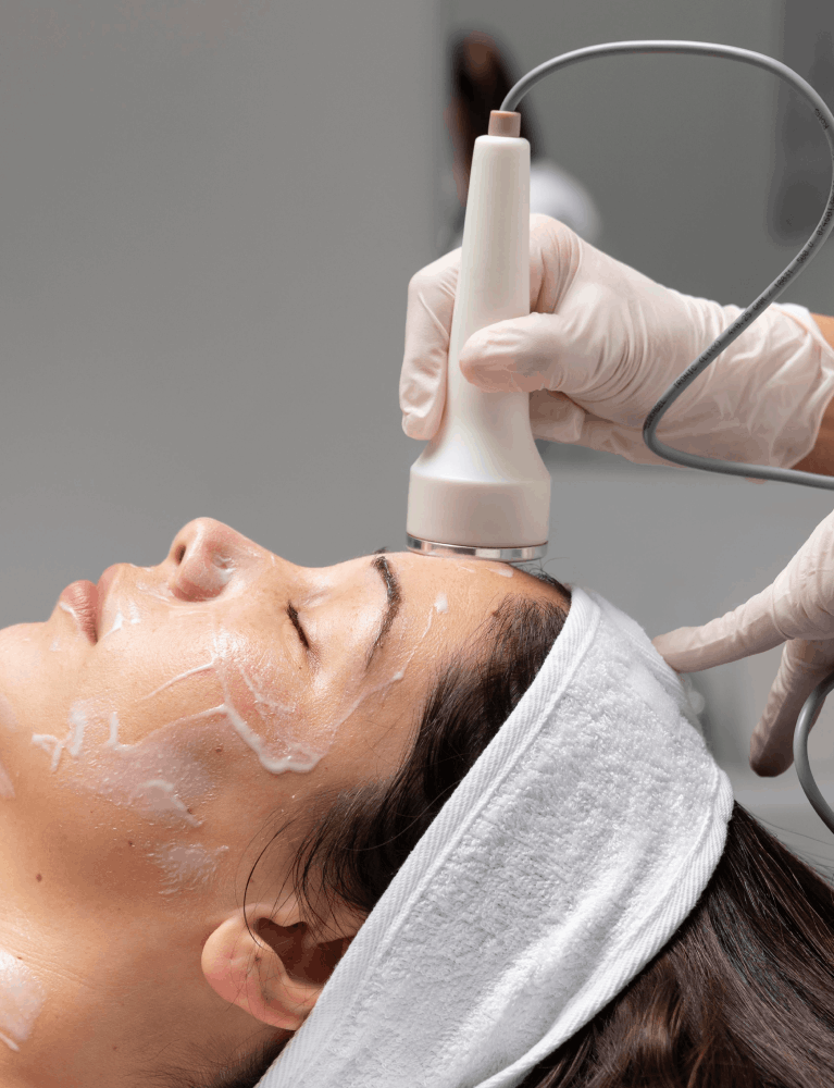 Dermatologist performing a medi facial treatment on a patient at a skin clinic in Chennai.