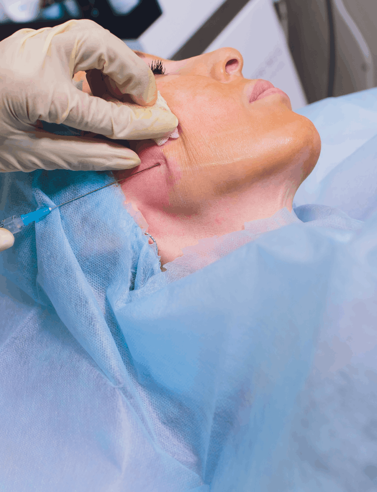 Dermatologist performing a skin lifting facial treatment on a patient at a skin clinic in Chennai.